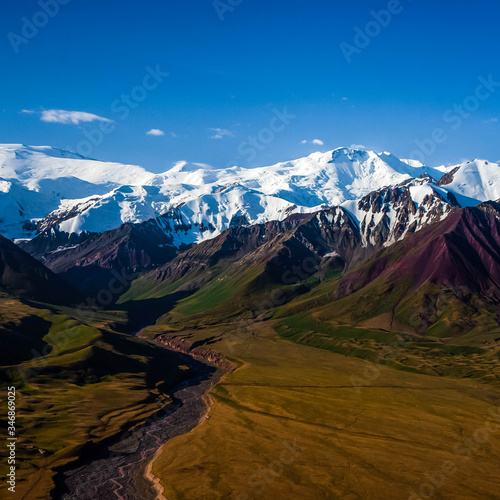 Beautiful mountainious landscape. Snowy mountain peaks. Hilly valley. photo