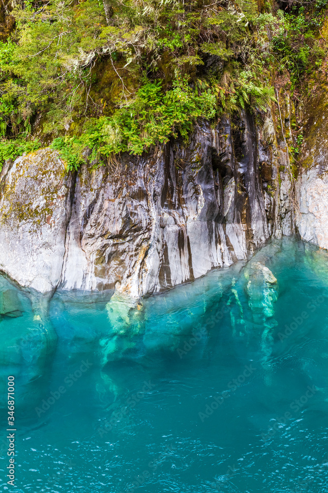 Steep cliffs above the blue water. Beauty of South Island, New Zealand
