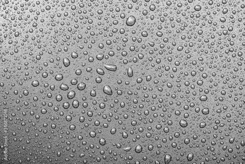 Close-up water drops on surface of grey backdrop or background, water texture, top view, high resolution