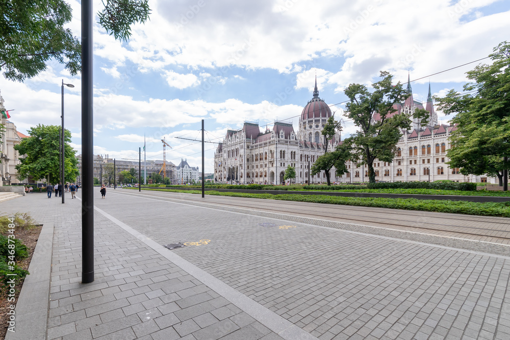 Hungarian parliament building and park from behind on a sunny day in summer season, angled view in Budapest, Hungary.