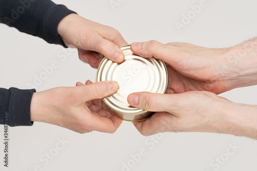 Hand-to-hand transfer of canned food. The concept of buying to accumulate food due to the panic of the Apocalypse and food scarcity.