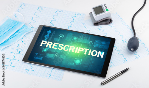 Tablet pc and medical stuff with PRESCRIPTION inscription, prevention concept