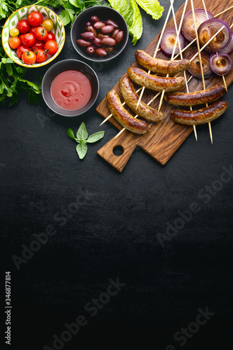 Grilled or roasted sausages and red onions ready to eat, top down view