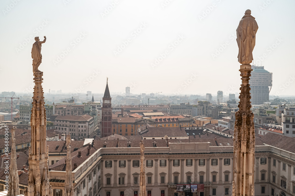 Ornate marble statues on the roof of famous Cathedral Duomo in Milan, Lombardy, Italy