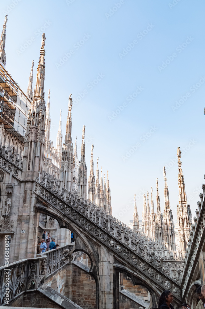 Ornate marble statues on the roof of famous Cathedral Duomo in Milan, Lombardy, Italy