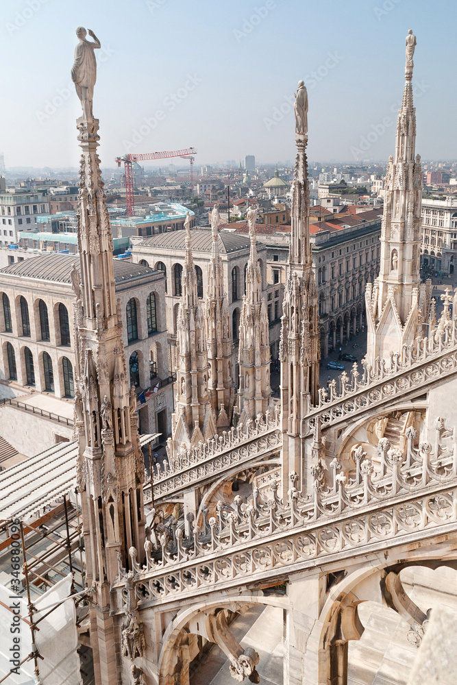 Ornate marble statues on the roof of famous Cathedral Duomo in Milan, Lombardy, Italy Ornate marble statues on the roof of famous Cathedral Duomo in Milan, Lombardy, Italy