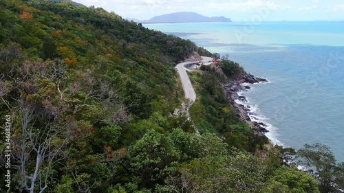 Wallpaper Mural Aerial view of Slow motion and following video of car running on the road beside the sea at southern of thailand. with autumn mountain in summer season. smooth drone shot. Torontodigital.ca