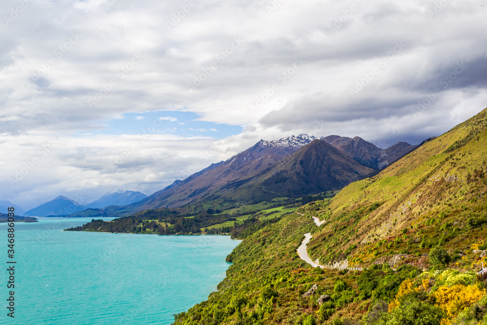 Scenic road over a turquoise lake. Lake Wakatipu. New Zealand Scenic road over a turquoise lake. Lake Wakatipu. New Zealand