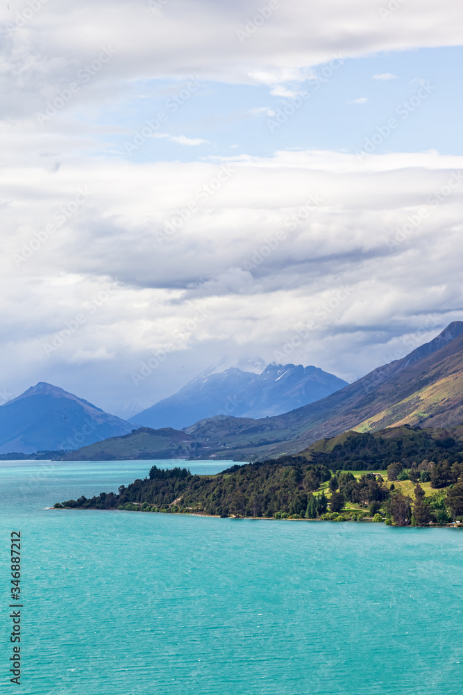 Pyramidal mountains and snow-capped peaks along the shores of Lake Wakatipu. South Island, New Zealand Pyramidal mountains and snow-capped peaks along the shores of Lake Wakatipu. South Island, New Zealand