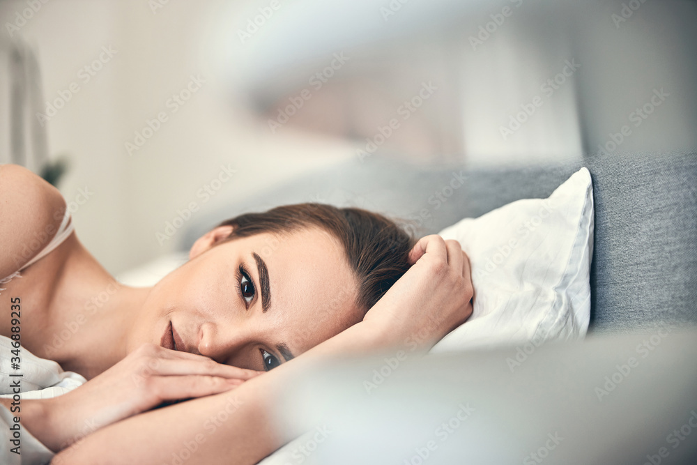 Happy Caucasian woman looking at camera in bedroom Happy Caucasian woman looking at camera in bedroom