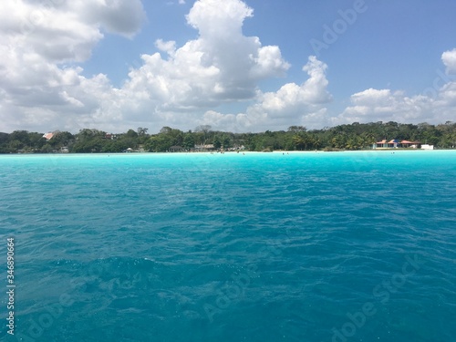 Beautiful ocean view with clean blue turquoise water, sunny day. Amazing background of island, Caribbean, Lagoon Bacalar. Calm secluded place without people, paradise