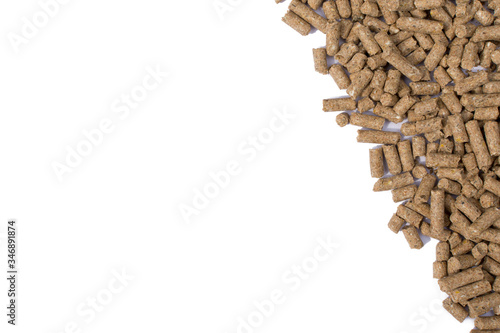 Granules of animal feed close up. Background texture isolated