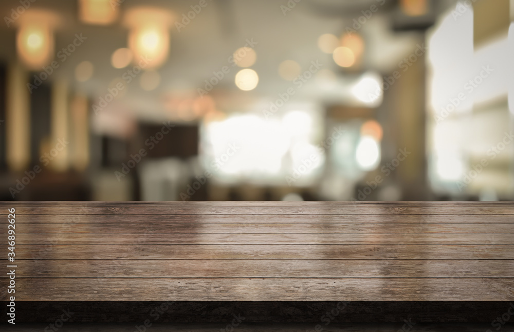Empty wooden table top with lights bokeh on blur restaurant background, 3D Rendering