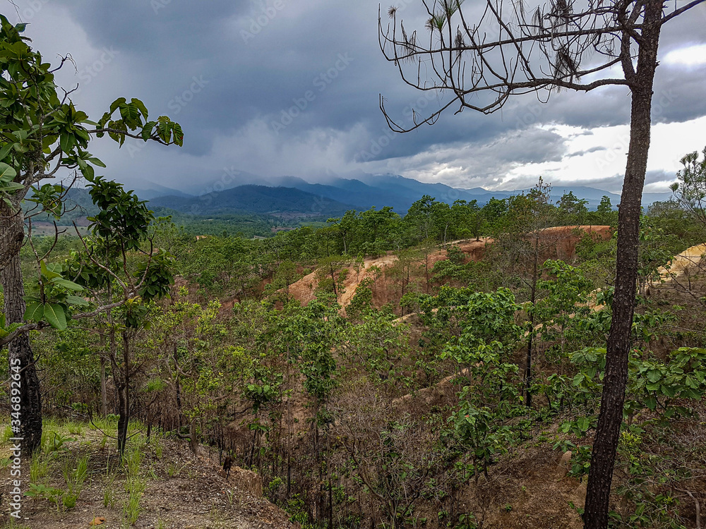 Dark weather clouds sun shine light right side rain forest trees sanstone yellow canyon pai north chiang mai mountains Dark weather clouds sun shine light right side rain forest trees sanstone yellow canyon pai north chiang mai mountains