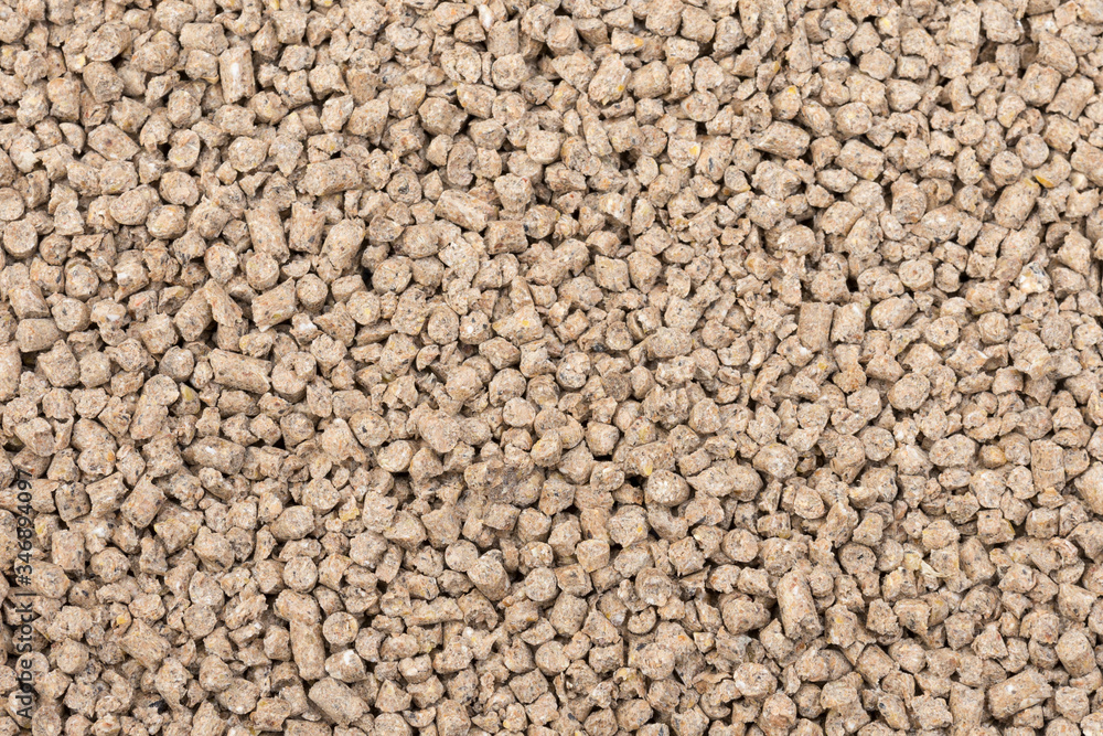 Granules of animal feed close up. Backgrounds texture
Granules of animal feed close up. Backgrounds texture