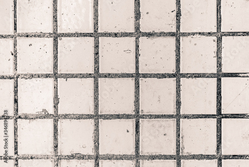 Old white small square dirty tile wall