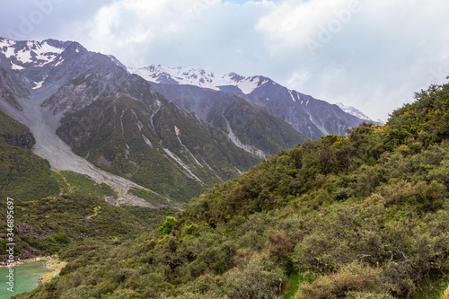 Sheer snow-capped cliffs over the Blue Lake. New Zealand