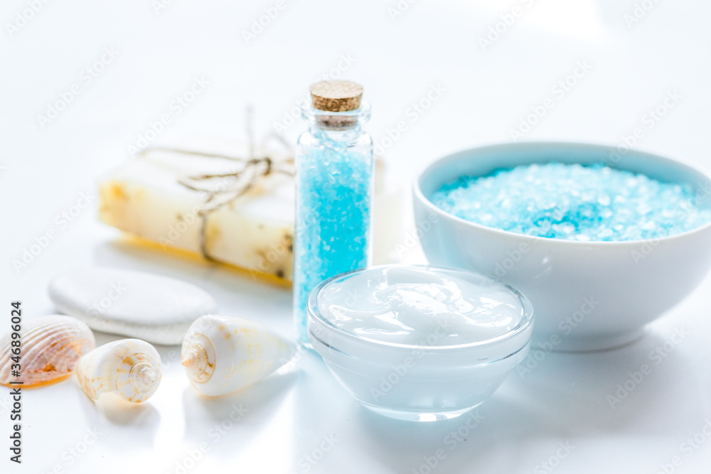 blue sea salt, soap and body cream on white desk background blue sea salt, soap and body cream on white desk background