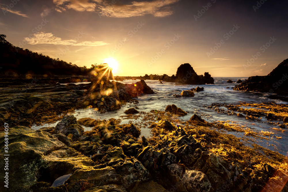 A Long Expose Magical Sunrise Shot with Flare, Lights the Rocks