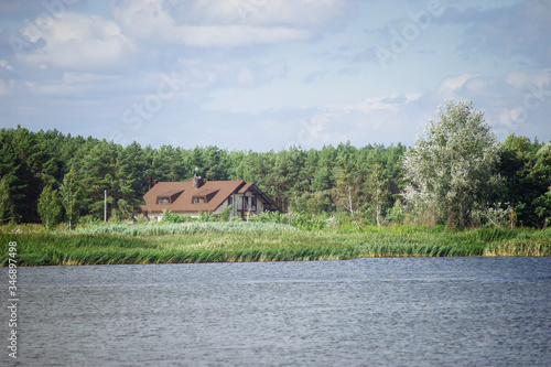 Rural landscape with river and house.