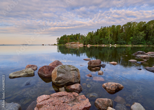 Spring walk along the Gulf of Finland on a wonderful calm morning in Lauttasaari next to the beautiful stones of Finnish nature.