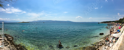 Canvas Print View of a rocky beach with bathers in Croatia