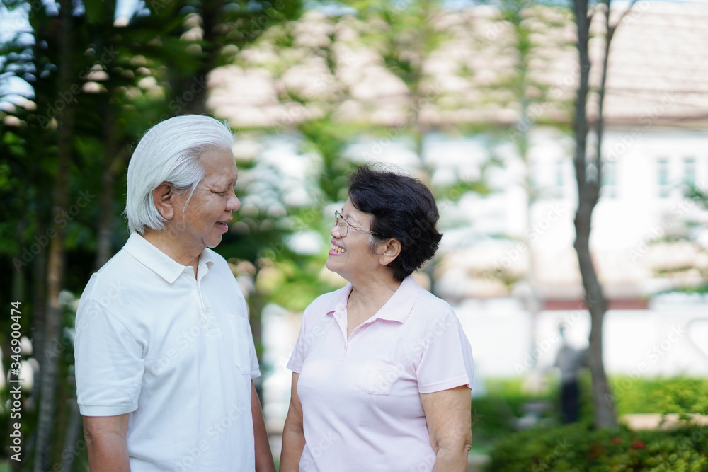 Happy old couples smiling in the park in the morning.Happy senior couple relaxing in autumn park.