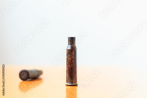 The rifle cartridges old, rusty, military on wood table.
