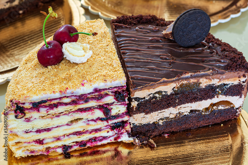 Slices of cakes . Cream cake and prague cake with fruit filling photo