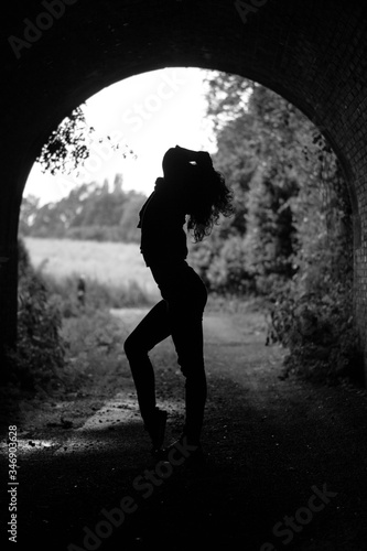 silhouette of a girl in a tunnel