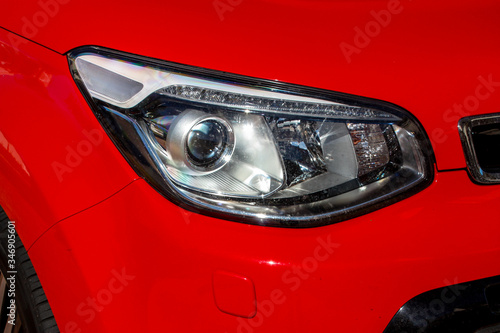Headlight of a modern red car © hanjosan