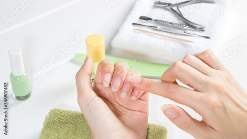 Manicure. Apply cuticle oil to unpainted nails. Moisturizing. Home nail care. Beauty salon, procedure, SPA. Beauty, style, makeup, fashion, lifestyle. photo