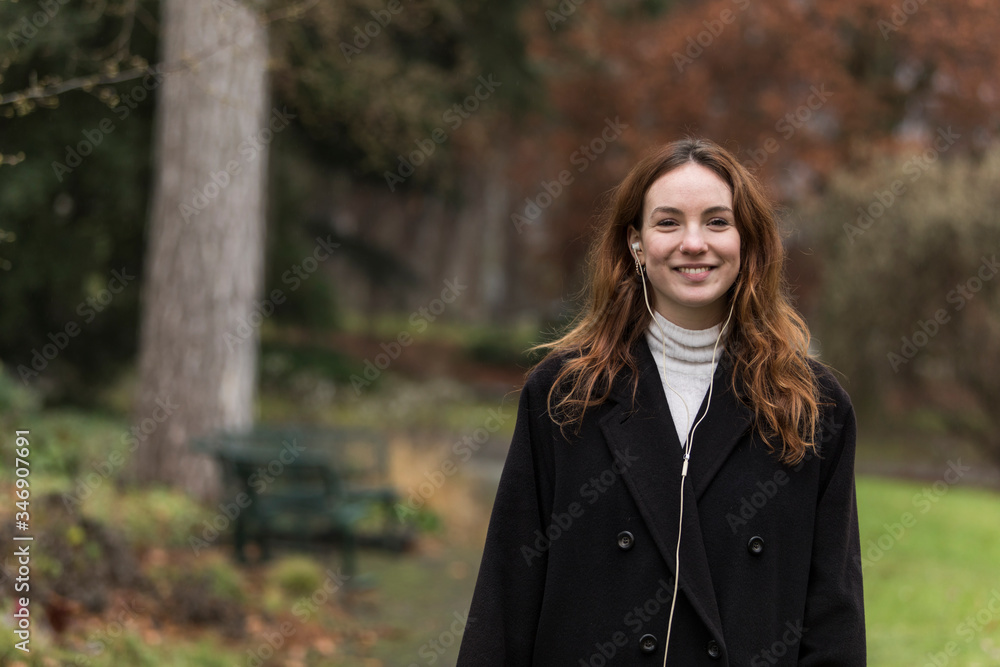 Young Woman with Toothy Smile Posing in Autumnal Park Young Woman with Toothy Smile Posing in Autumnal Park