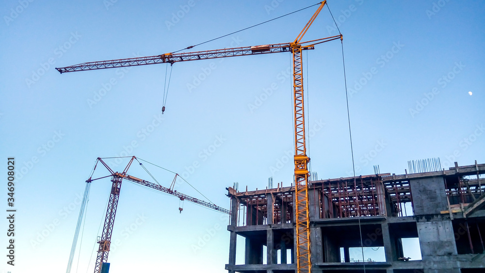 building under construction with cranes