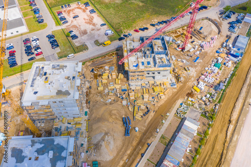 construction of new apartment buildings in the city residential area. construction site with tower cranes. aerial view