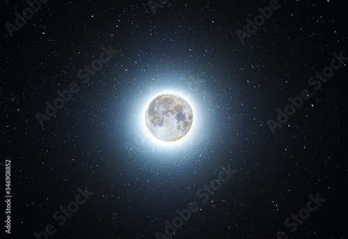 Full moon glowing in the starry sky. Night photography. Astronomical background. Deep space.
