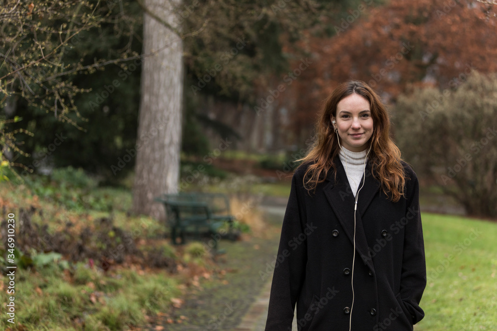 Young Woman with Genuine Smile in Autumnal Park Young Woman with Genuine Smile in Autumnal Park