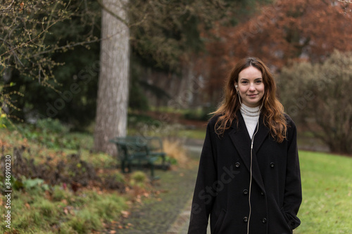 Young Woman with Genuine Smile in Autumnal Park