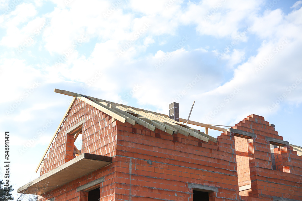 construction of a country brick house. top floor of a country house against the sky. unfinished house without a roof. construction of a country brick house. top floor of a country house against the sky. unfinished house without a roof.