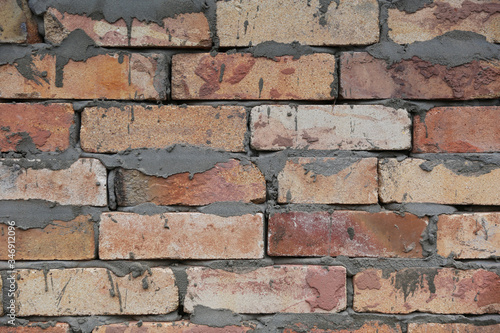 old brick wall with untidy cement
