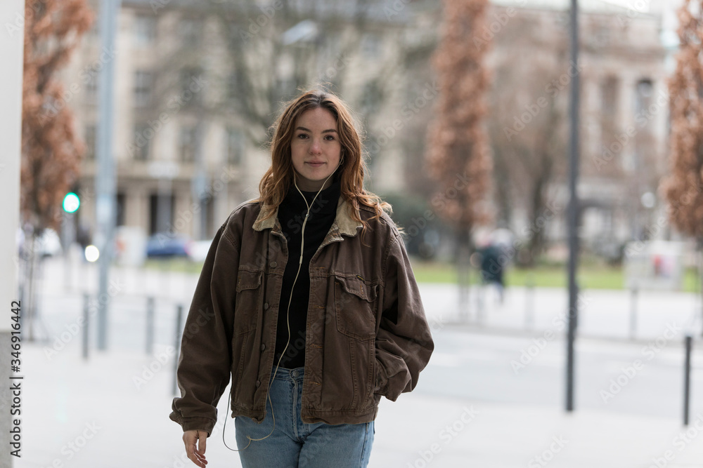 Young Woman with Hand in Jacket Pocket Looking at Camera Young Woman with Hand in Jacket Pocket Looking at Camera