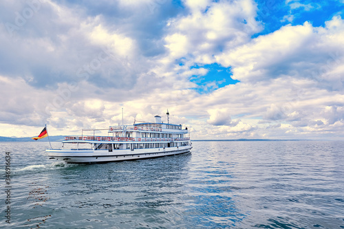 Ferry sails through calm waters under cloudy skies