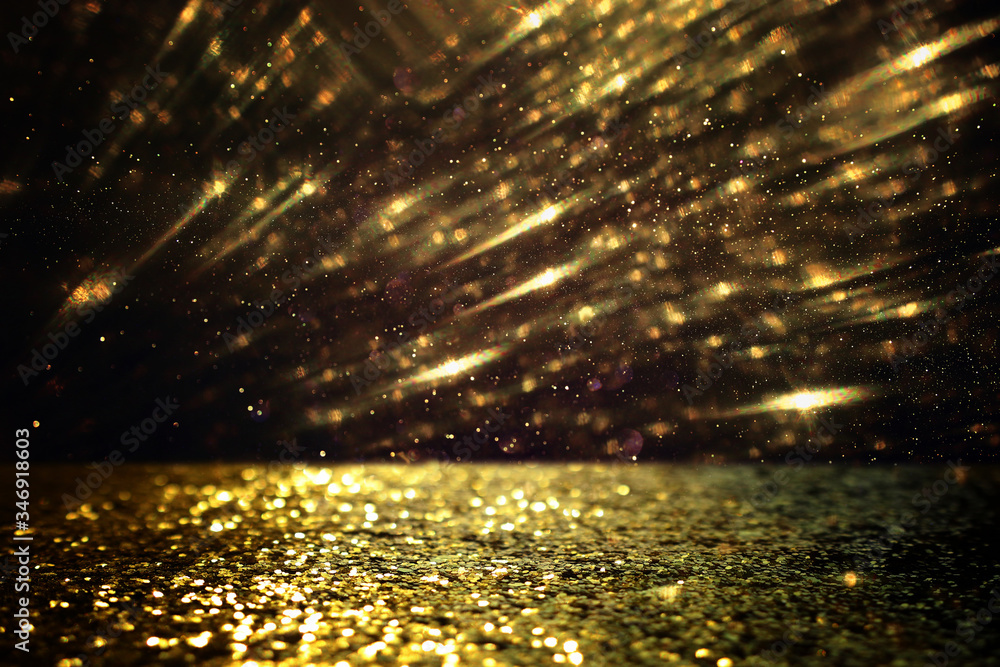 background of abstract glitter lights. gold and black. de focused background of abstract glitter lights. gold and black. de focused