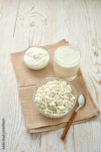 Glass bowls with fresh village cottage cheese and sour cream, glass with yogurt. Healthy food. Dairy producst.