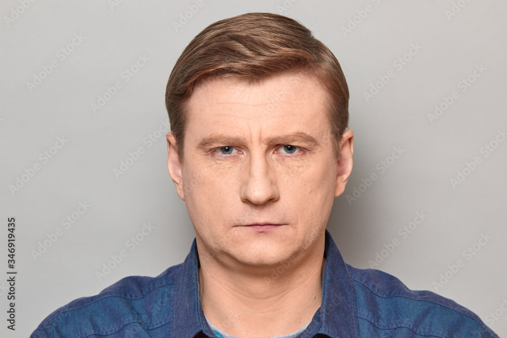 Portrait of blond mature man with neutral expression on face Portrait of blond mature man with neutral expression on face