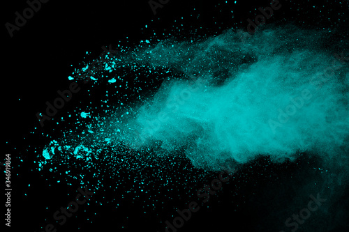 green powder explosion isolated on Black background.Colored dust splash isolated.