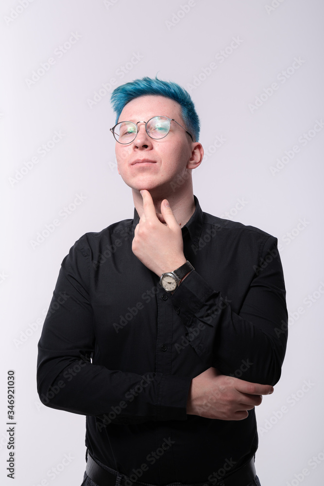 Young stylish blue haired man flirty and lusty stares in a camera, studio portrait on light background Young stylish blue haired man flirty and lusty stares in a camera, studio portrait on light background