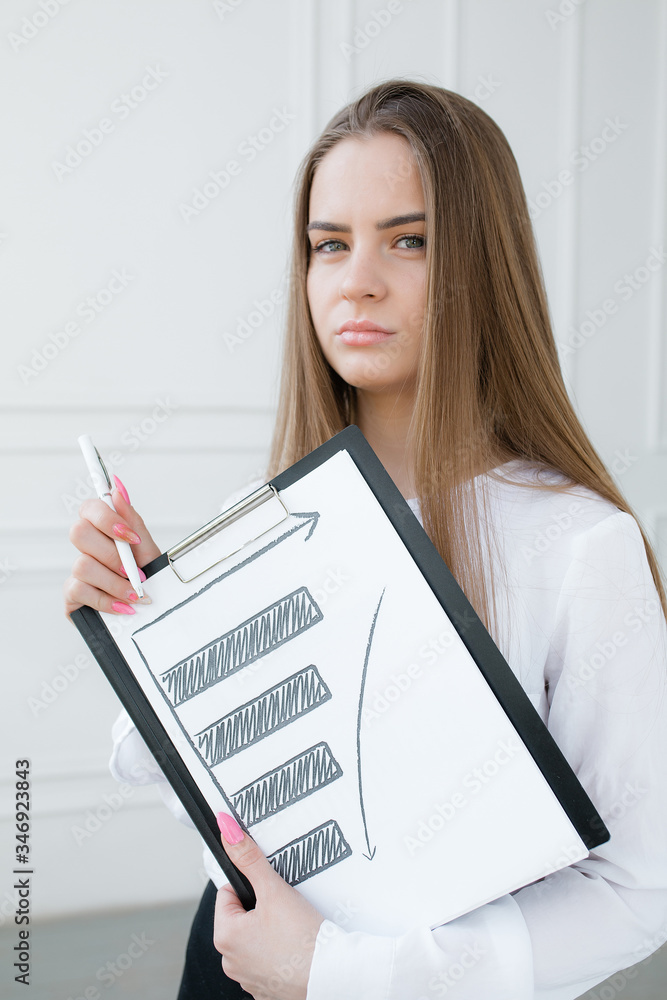 Sad bank office worker is holding a drawn graph of falling stock prices due to the financial crisis. Sad bank office worker is holding a drawn graph of falling stock prices due to the financial crisis.