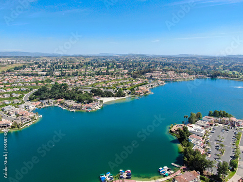 Fototapeta Naklejka Na Ścianę i Meble -  Aerial view of Lake Mission Viejo, with recreational facilities, surrounded by private residential and condominium communities. Orange County, California, USA