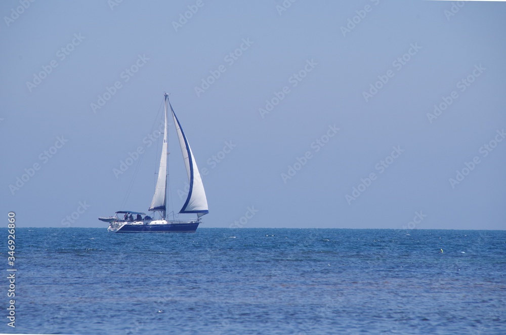 Sail Boat Sailing In Sea Against Clear Sky